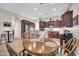 Open kitchen with wood cabinets, granite countertops, and breakfast nook at 3125 W Desert Ln, Laveen, AZ 85339