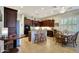 Bright kitchen features dark wood cabinetry, granite counters, and a cozy dining area at 3125 W Desert Ln, Laveen, AZ 85339