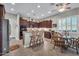 Bright kitchen with stainless steel appliances, granite counters, dark wood cabinets, and adjacent breakfast nook at 3125 W Desert Ln, Laveen, AZ 85339