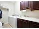 Well-equipped laundry room featuring a washer and dryer with overhead cabinets at 3125 W Desert Ln, Laveen, AZ 85339