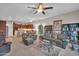 Expansive living area boasts plush leather seating, ceiling fans, and an adjacent open-concept kitchen at 3125 W Desert Ln, Laveen, AZ 85339
