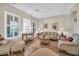 Charming living room with wood floors, plantation shutters, and ample seating at 3125 W Desert Ln, Laveen, AZ 85339