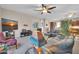Cozy living room showcasing comfortable seating, a TV, and seamless flow to kitchen at 3125 W Desert Ln, Laveen, AZ 85339