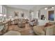 Sophisticated living room with stylish furniture, wood flooring, and adjacent arched entryway at 3125 W Desert Ln, Laveen, AZ 85339