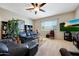 Bright living room with neutral walls, TV, fireplace, and comfortable seating at 3125 W Desert Ln, Laveen, AZ 85339