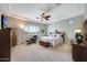 Bright main bedroom featuring a king bed, dark wood furniture, tray ceiling, and large windows at 3125 W Desert Ln, Laveen, AZ 85339