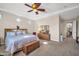Serene main bedroom with tray ceiling, sitting area, and carpet floors at 3125 W Desert Ln, Laveen, AZ 85339