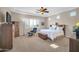 Comfortable main bedroom with plantation shutters, carpet floors, and fan at 3125 W Desert Ln, Laveen, AZ 85339