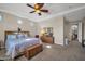 Large primary bedroom with a trey ceiling, carpeted floors, and access to an en-suite bathroom at 3125 W Desert Ln, Laveen, AZ 85339