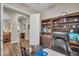 Home office featuring built-in bookshelves and plenty of natural light at 3125 W Desert Ln, Laveen, AZ 85339