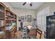 Inviting home office with natural light, built-in shelving, and functional workspace at 3125 W Desert Ln, Laveen, AZ 85339