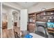 Bright office with a desk, chair, shelving, and an open door to view into the home at 3125 W Desert Ln, Laveen, AZ 85339
