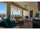 Relaxing covered patio featuring stylish furniture, perfect for entertaining guests at 3125 W Desert Ln, Laveen, AZ 85339