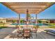 Charming patio with an umbrella table set, perfect for outdoor relaxation by the pool at 3125 W Desert Ln, Laveen, AZ 85339