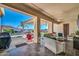Inviting covered patio with comfortable seating overlooking a stunning pool and mountain view, perfect for outdoor entertaining at 3125 W Desert Ln, Laveen, AZ 85339