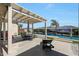 Outdoor patio with a pergola and a dining set overlooking a beautiful pool and mural at 3125 W Desert Ln, Laveen, AZ 85339