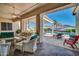 Charming outdoor patio featuring stylish furniture and a relaxing view of the sparkling pool and landscaped backyard at 3125 W Desert Ln, Laveen, AZ 85339