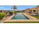 Stunning rectangular pool with water feature surrounded by lush landscaping and a patio area, perfect for relaxation and entertainment at 3125 W Desert Ln, Laveen, AZ 85339