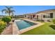 Beautiful backyard pool with lush green lawn and comfortable lounge area, ideal for enjoying sunny days and outdoor gatherings at 3125 W Desert Ln, Laveen, AZ 85339