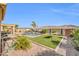 A beautiful pool area featuring a pool, synthetic grass, and lounge chairs surrounded by a block wall fence at 3125 W Desert Ln, Laveen, AZ 85339