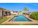 Stunning backyard pool with modern design, mature landscaping, and outdoor lounging area at 3125 W Desert Ln, Laveen, AZ 85339