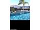 Sparkling pool with rock waterfall feature, muraled block wall, and mountain views at 3125 W Desert Ln, Laveen, AZ 85339