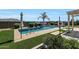 A serene backyard featuring a sparkling pool, and lush landscaping at 3125 W Desert Ln, Laveen, AZ 85339