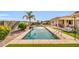 Long pool with access ladder and water feature, surrounded by synthetic grass and concrete at 3125 W Desert Ln, Laveen, AZ 85339