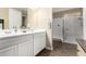 Bright bathroom featuring a double sink vanity and step-in shower at 35919 N Loemann Dr, San Tan Valley, AZ 85143