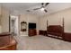 Neutral bedroom with wooden furniture, a ceiling fan, and access to en-suite bathroom and closet at 35919 N Loemann Dr, San Tan Valley, AZ 85143