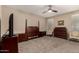 Spacious bedroom featuring a ceiling fan, neutral walls and carpet, and wooden furniture at 35919 N Loemann Dr, San Tan Valley, AZ 85143