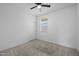 Spare bedroom featuring a ceiling fan, closet, and window with blinds on carpeted floors at 36987 N Sidewinder Dr, San Tan Valley, AZ 85140
