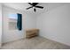Minimalist bedroom featuring a small wood desk, ceiling fan, and window with curtains at 36987 N Sidewinder Dr, San Tan Valley, AZ 85140