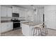 Kitchen with white cabinets, granite counters, a stainless steel microwave, and a center island with seating at 36987 N Sidewinder Dr, San Tan Valley, AZ 85140