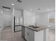 Kitchen island with a stainless steel sink, white cabinets, granite countertops, and stainless steel appliances at 36987 N Sidewinder Dr, San Tan Valley, AZ 85140