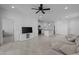 Open-concept living area with tile floors, kitchen island with stools, and a comfortable sectional sofa at 36987 N Sidewinder Dr, San Tan Valley, AZ 85140