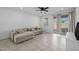 Open living area featuring tile floors, a sectional sofa, and a sliding glass door to the patio at 36987 N Sidewinder Dr, San Tan Valley, AZ 85140