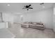 Bright and airy living room featuring neutral tile floors and a large sectional sofa at 36987 N Sidewinder Dr, San Tan Valley, AZ 85140