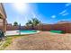 Spacious backyard features a pool, block fence, and beautiful landscaping at 40010 W Ganly Way, Maricopa, AZ 85138
