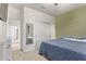 Bedroom with plush carpet, a large closet with sliding doors and a sliding glass door to the ensuite bathroom at 40010 W Ganly Way, Maricopa, AZ 85138