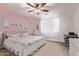 Serene main bedroom with a calm color palette, carpeted floors, and a large window offering natural light at 40010 W Ganly Way, Maricopa, AZ 85138