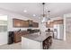 Well-equipped kitchen with granite counters, stainless appliances, and a large island with barstool seating at 40010 W Ganly Way, Maricopa, AZ 85138