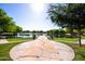 Walking path leading to community lake with seating area at 40010 W Ganly Way, Maricopa, AZ 85138