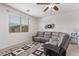 Relaxing living room area featuring neutral decor, large windows, and plush, oversized seating for comfort at 40010 W Ganly Way, Maricopa, AZ 85138