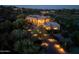 Aerial view showcasing the beautifully landscaped property and the surrounding desert landscape with illuminated driveway at 41667 N 113Th Pl, Scottsdale, AZ 85262