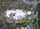 Stunning aerial view of a desert home with pool, stone walkways, and mature landscaping at 41667 N 113Th Pl, Scottsdale, AZ 85262