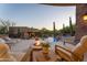 Relaxing backyard with a fire pit, lounge chairs, and pool view, creating an inviting atmosphere for outdoor enjoyment at 41667 N 113Th Pl, Scottsdale, AZ 85262