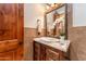 Elegant powder bathroom featuring a custom vanity with marble top and decorative mirror at 41667 N 113Th Pl, Scottsdale, AZ 85262