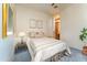 Cozy bedroom featuring a comfortable bed, stylish decor, and a glimpse into the bathroom at 41667 N 113Th Pl, Scottsdale, AZ 85262