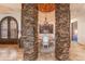 Elegant dining room with brick ceiling, chandelier, and stone pillars at 41667 N 113Th Pl, Scottsdale, AZ 85262